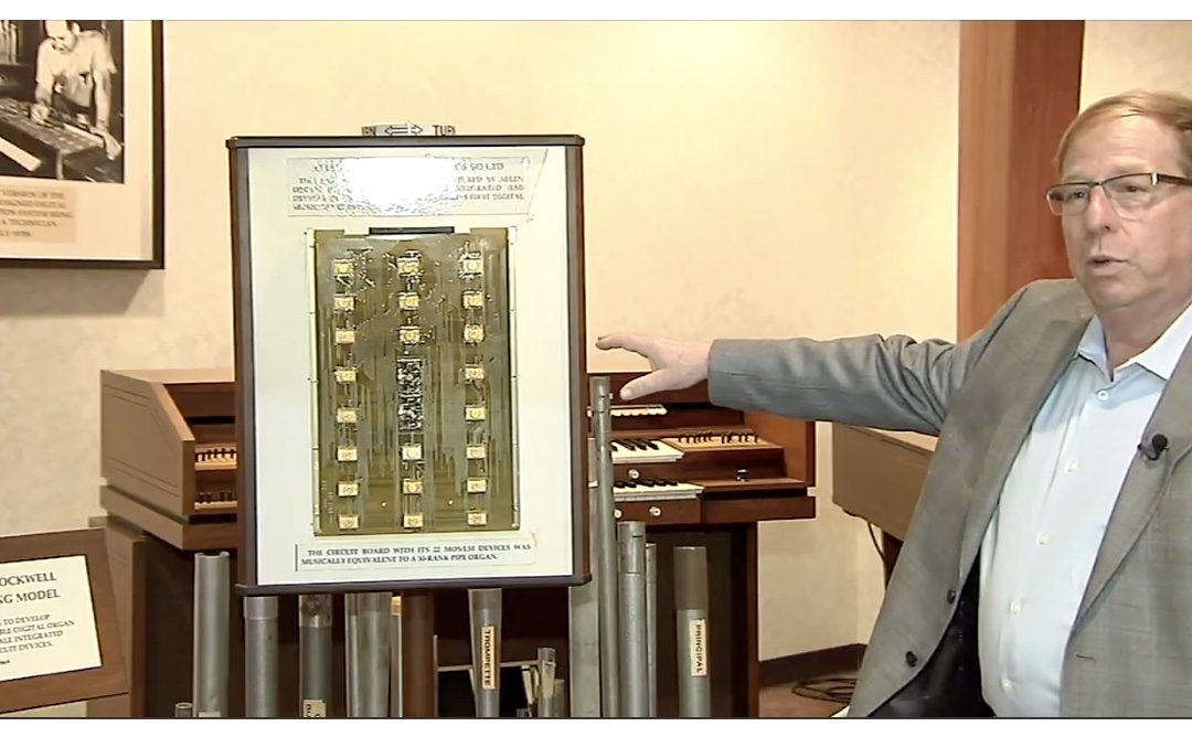 Allen Organ President Steven Markowitz displays the MOS board of 22 custom, integrated circuits. In 1971, it was the most sophisticated computer board in any product in the world.