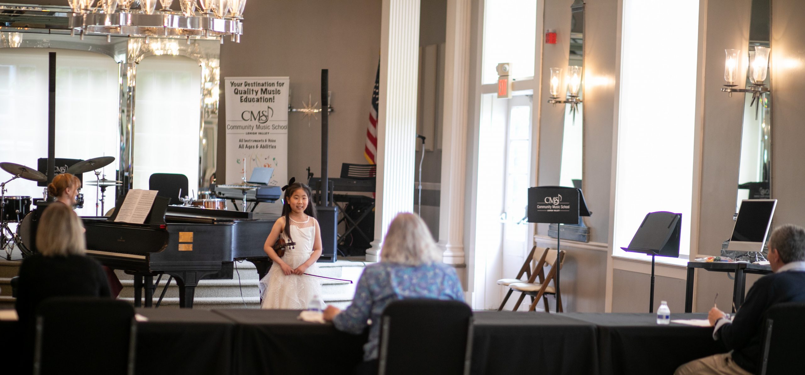 A violin student auditions before a panel of judges for a scholarship to Community Music School.