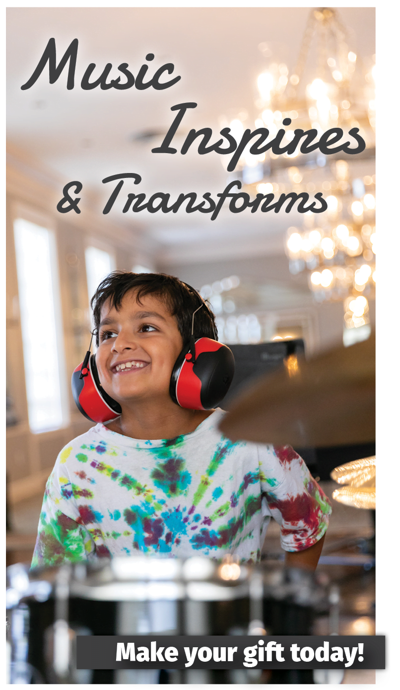 2022 Annual Appeal - holiday giving season - Music Inspires and Transforms - Make Your Gift Today - Image of a young boy in a drum lesson wearing a tie die tshirt and headphones with a huge smile on his face