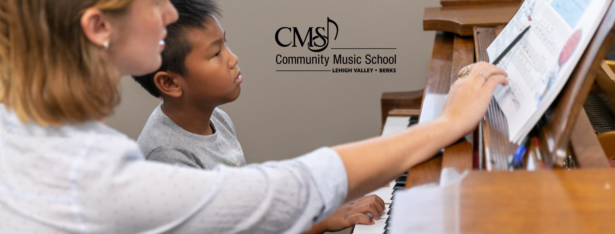 Kelly Hooper, piano teacher gives a piano lesson to a young student at Community Music School.