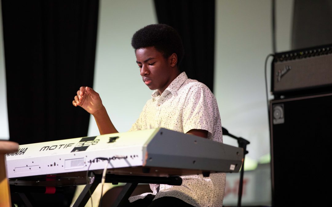 CMS student Joshua Trotter, playing keyboard on the stage of Plaza tropical at musikfest