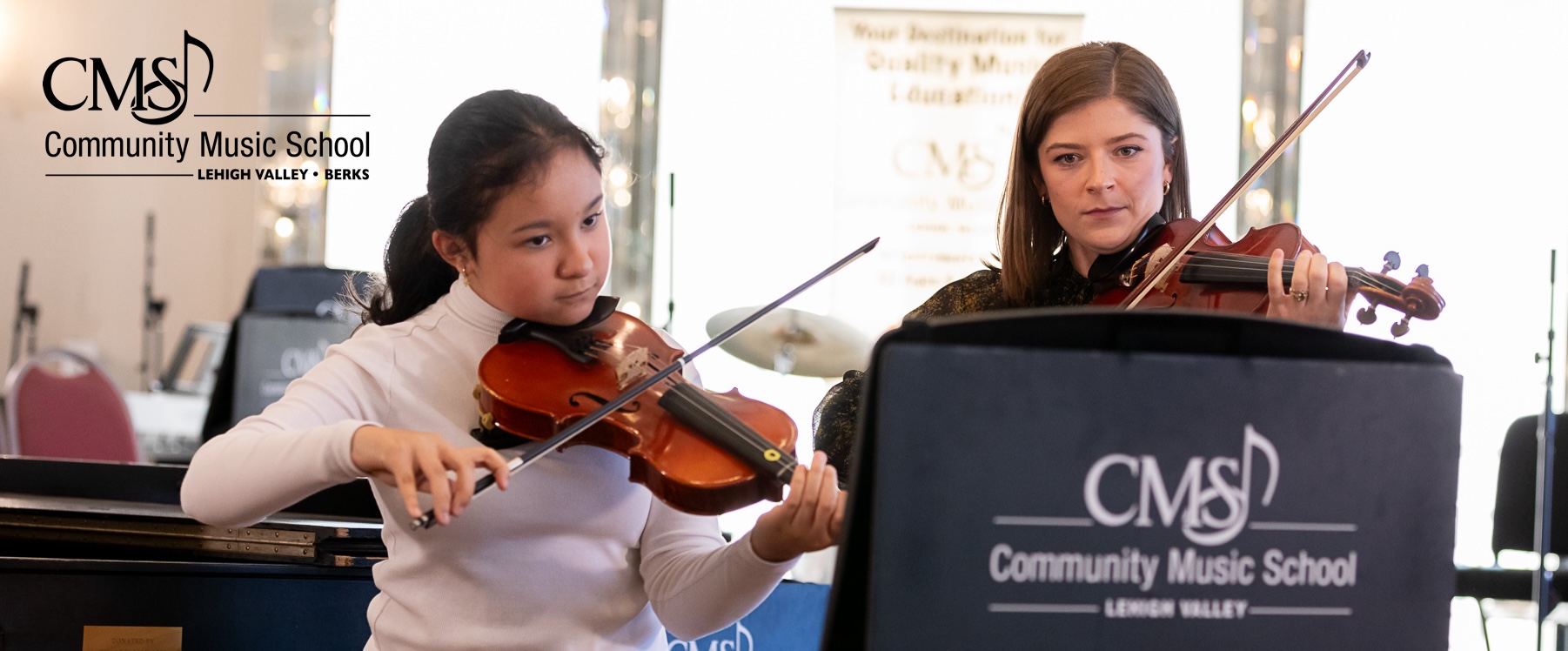 violin teacher and a student perform in a recital at community music School